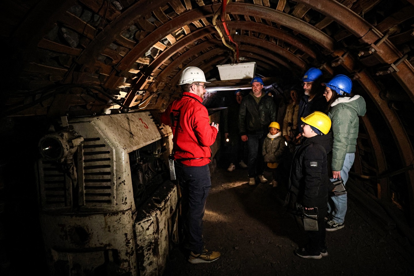 groupe de visiteurs à coté du locotracteur dans la mine du Puits des Glénons